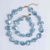 Χειροποίητα γαλάζια (baby blue) κρεμαστά σκουλαρίκια CUORO με ασύμμετρες πέτρες από φίλντισι